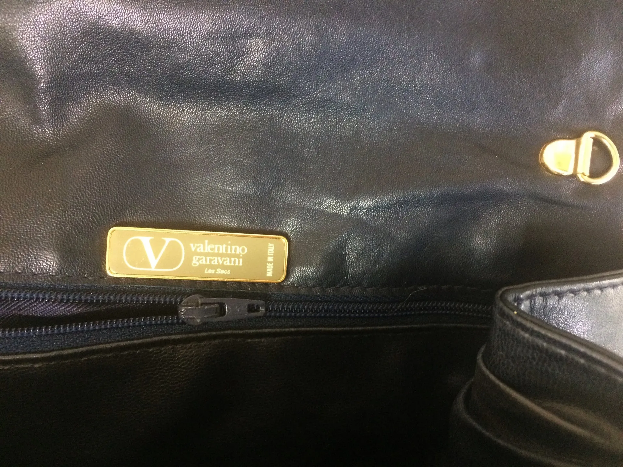 Vintage Valentino Garavani, Black nappa leather clutch purse, shoulder bag with tied bow, ribbon and V logo motif at front. 060616r4